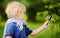 Charming kid exploring nature with magnifying glass