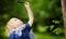 Charming kid exploring nature with magnifying glass