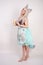 Charming kitty girl in a kitchen apron with a paper Cup of coffee in her hands on a white Studio background