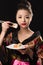 Charming Korean girl with dish sushi rolls