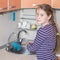 Charming little girl doing household chores.