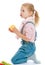Charming little girl kneeling holding an apple.
