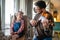 Charming little girl learning to play the violin with an artistic music teacher.