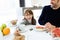 Charming little girl taking chocolate cookie and smiling at the camera on kitchen at home