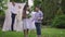 Charming Middle Eastern boy and girl standing outdoors with wedding bouquet and ring box laughing as blurred loving