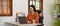 Charming millennial Asian businesswoman working at her desk, using laptop