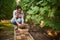 Charming multiethnic woman, amateur wine grower, vintner harvesting ripe grapes, cultivated in vineyard in own eco farm