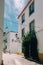 Charming narrow cobblestone alley street between whitewashed houses and walls in old town Cascais, Portugal