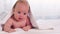 Charming newborn baby laughs after bath