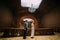 Charming newlywed pair dancing at the background of vintage victorian mansion royal wooden interior