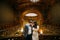 Charming newlywed pair embracing at the background of vintage victorian mansion royal wooden interior