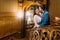 Charming newlywed pair embracing and kissing leaning on balustrade at gorgeous antique stairs with the background of