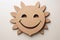 A charming paper cut-out of a smiling sun, bringing a touch of warmth and happiness in a playful design.