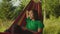Charming peaceful asian woman traveler in hammock enjoying leisure in mountains during trek