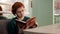 Charming person reading book closeup red hair. Female leisure in pages novel 4K