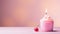 Charming pink candle on birthday cupcake, set against captivating light pink background