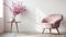 Charming pink flowers gracefully adorn a glass vase, perched elegantly on a rustic wooden table beside a petite chair, creating a