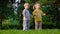 Charming playful little children brother and sister have fun dancing on the lawn