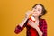 Charming positive young woman in checkered shirt eating fries