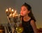 Charming Preteen Girl Blowing out Candles in Vintage Chandelie.