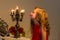 Charming Preteen Girl Blowing out Candles in Vintage Chandelier