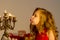 Charming Preteen Girl Blowing out Candles in Vintage Chandelier