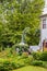 Charming seating area on landscaped patio outside of two story stucco house with far decor and pumpkin - blurred trees in