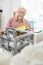 Charming senior man carrying out 3D printer maintenance