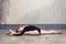 Charming slender young adult woman doing the splits