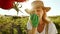 A charming smiling middle aged woman is growing vegetables and checking the harvest. A lady evaluates the ripeness of