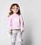 Charming smiling red-haired little girl in sportswear and funny glasses