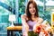 Charming smiling young asian woman standing gives bouquet of flowers indoors in cafe, Giving Spring flowers