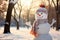 A charming snowman, wearing an enchanting hat and sporting a carrot nose, situated in a snowy landscape with copy space