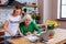 Charming social volunteer showing pensioner loan presentation on laptop