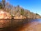 Charming spring landscape with sandstone cliffs on the river bank, fast flowing and clear river water