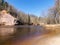 Charming spring landscape with sandstone cliffs on the river bank, fast flowing and clear river water