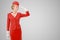 Charming Stewardess Dressed In Red Uniform On Gray Background.