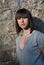 Charming teen in casual posing against a rock wall