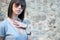 Charming teen in casual posing against a rock wall