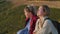 charming teen girls friends are relaxing on slope of mount at summer