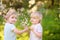 Charming toddler girl and little boy outdoors portrait in spring day