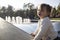 Charming toddler girl makes faces and grimaces against the backdrop of the park. the child plays cheerfully. happy childhood