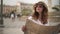 Charming tourist with map enjoying view of a street in Nice, France, pan shot