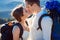 Charming tourist wedding couple kissing on the mountain peak close up