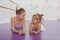 Charming two young ballerinas practicing at ballet class