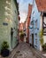 Charming urban alley with various architectural structures in Bremen, Germany.