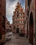 Charming urban alley with various architectural structures in Bremen, Germany.