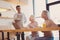 Charming waiter serving salad to two senior businesswomen