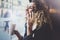 Charming woman with beautiful smile using mobile phone during rest in coffee shop. Blurred background.