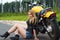 Charming woman biker sitting on asphalt with motorcycle